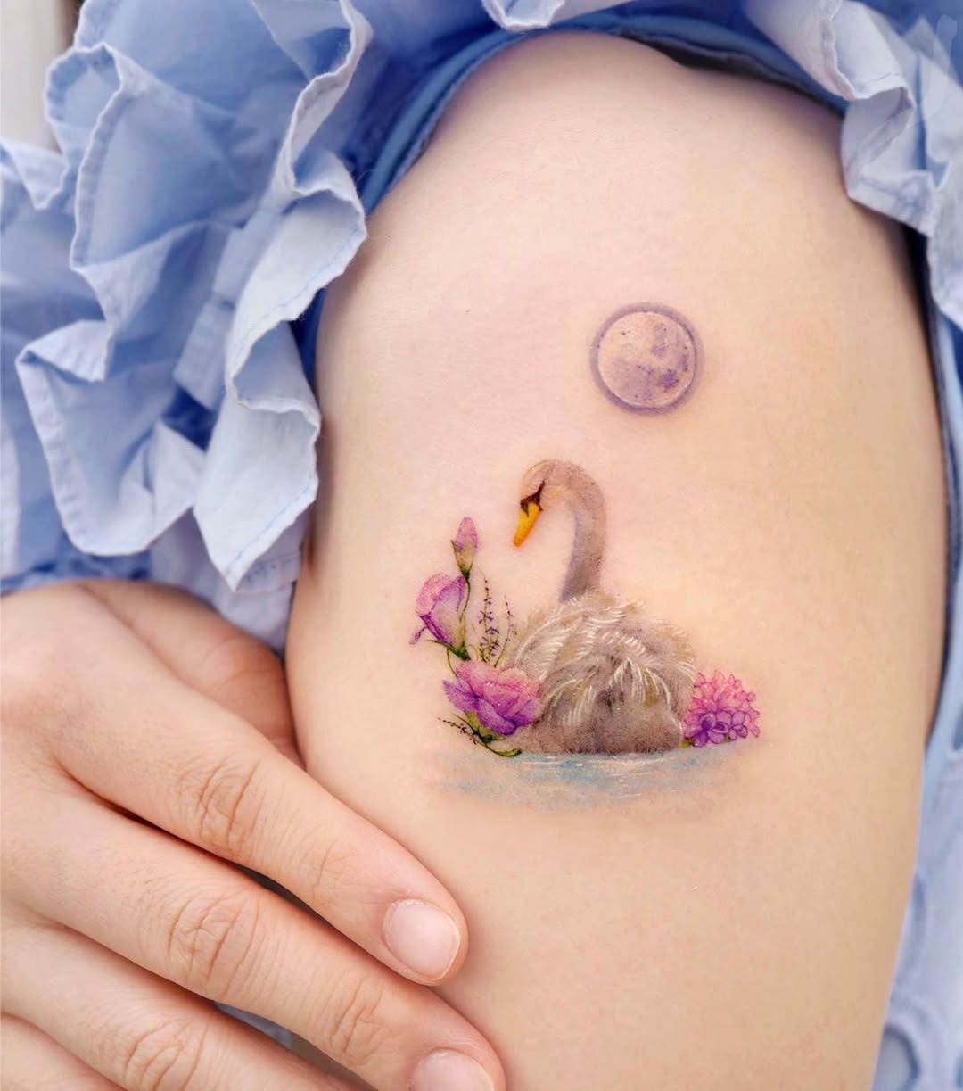 Whimsical swan tattoo with floral accents Tattoo Design