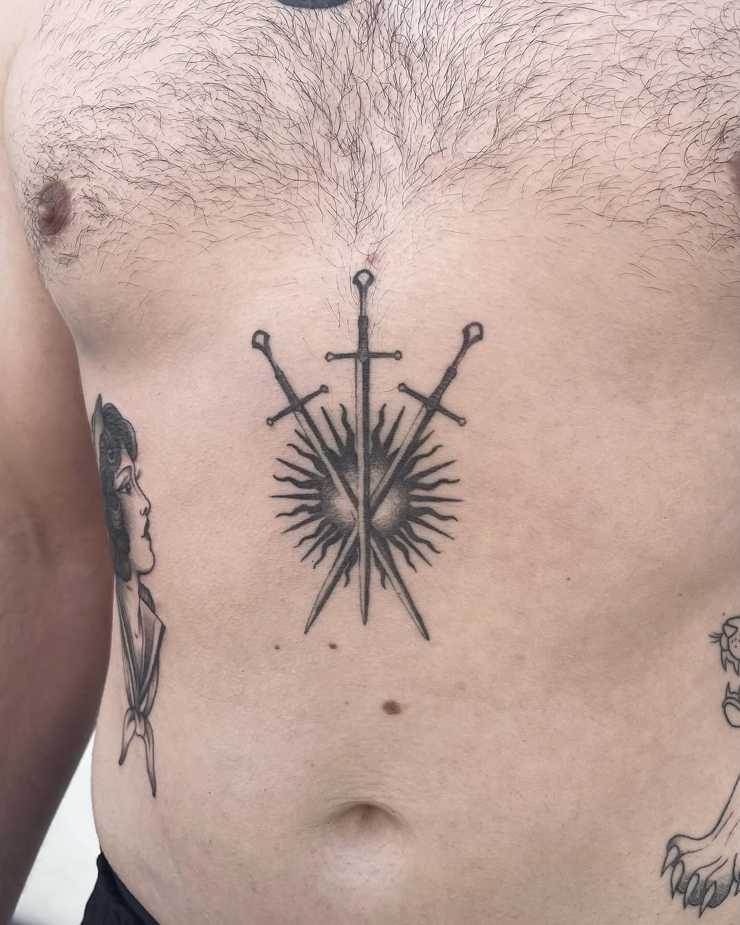 Bold chest tattoo featuring three striking swords Tattoo Design