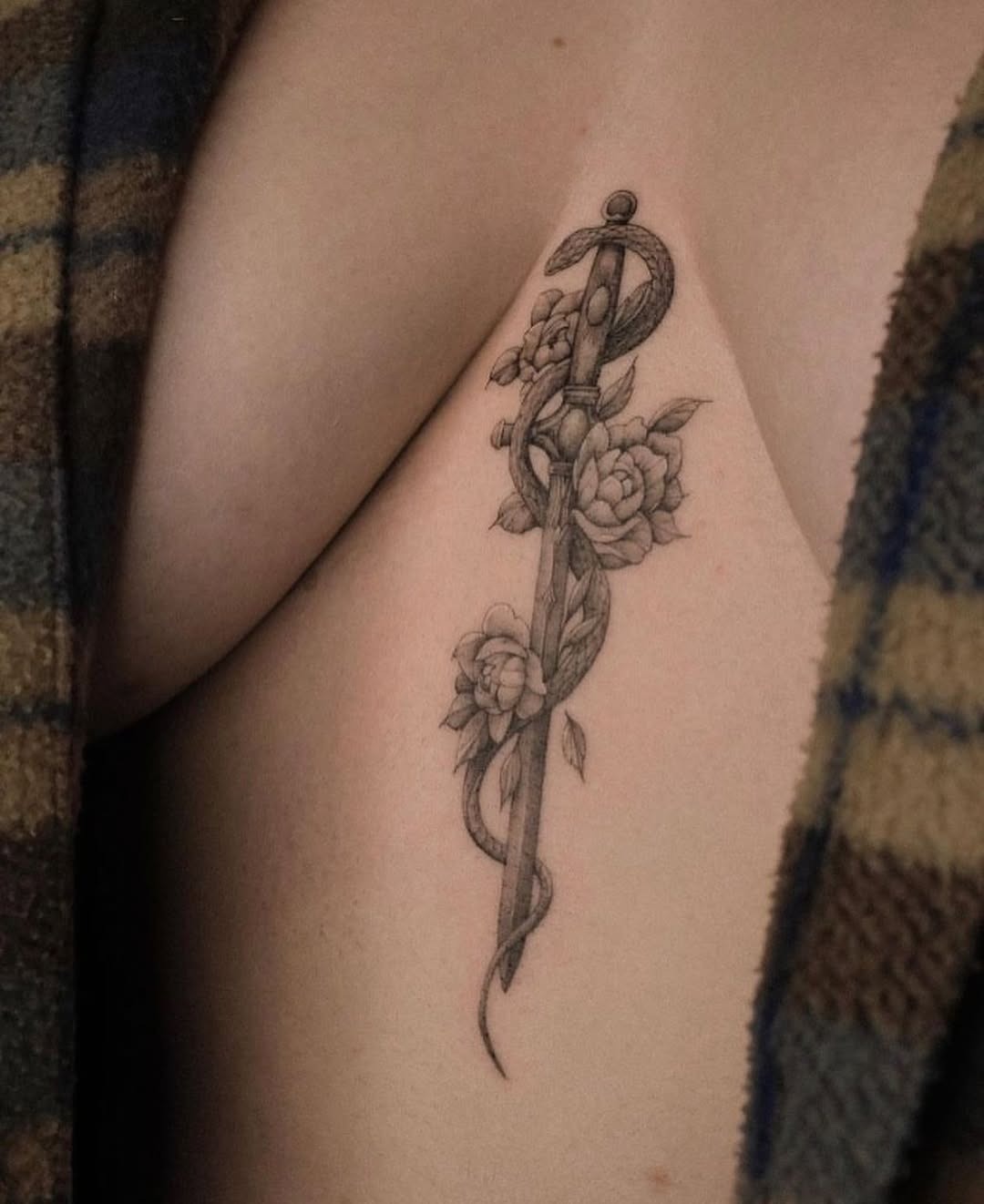 Elegant sword tattoo entwined with roses Tattoo Design