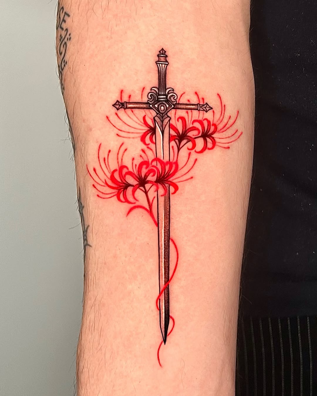 Elegant sword tattoo with floral accents Tattoo Design