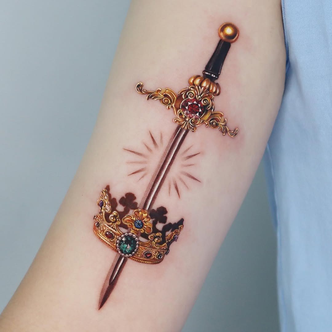 Intricate sword crowned with royal elegance Tattoo Design