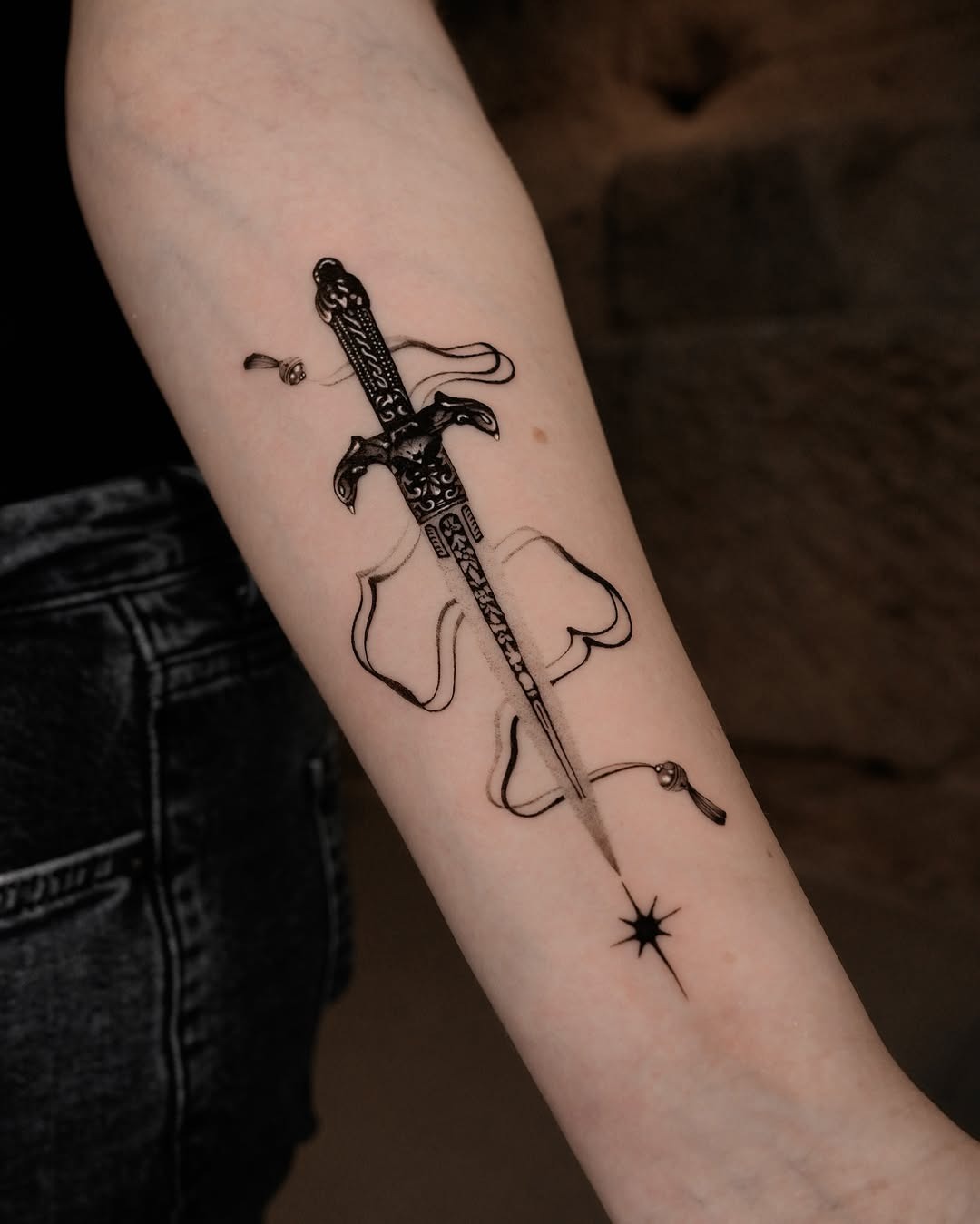 Intricate sword tattoo with flowing design elements Tattoo Design