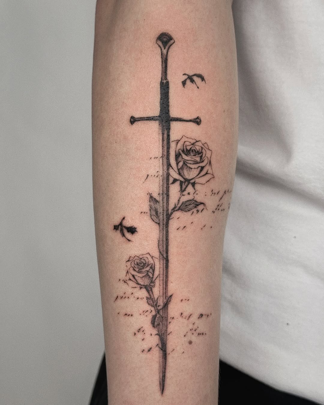 Intricate sword with blooming roses tattoo design Tattoo Design