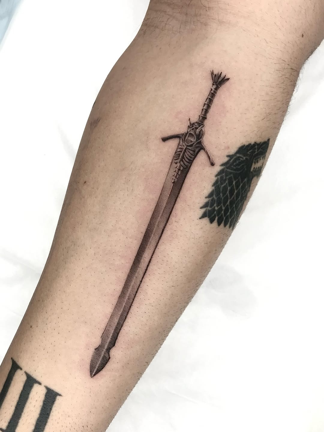 Realistic sword tattoo showcasing intricate detailing Tattoo Design
