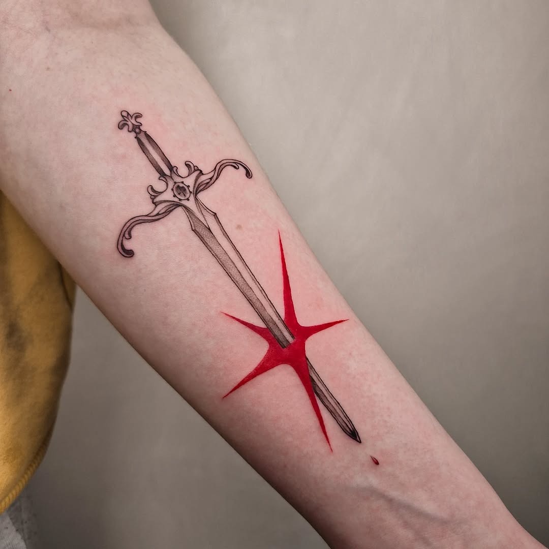 Striking sword tattoo with vibrant red accents Tattoo Design
