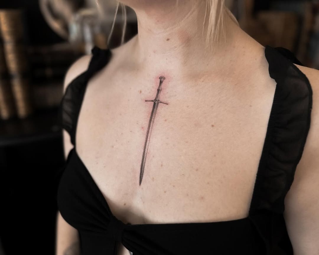 Stunning sword tattoo on the chest Tattoo Design