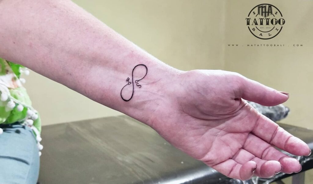 Bold Om Symbol Tattoo on Arm Tattoo Design