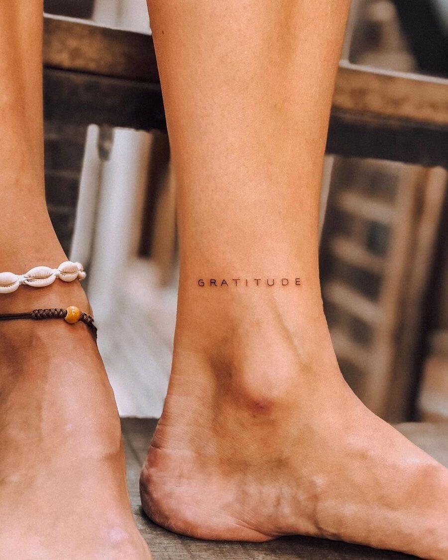 Minimalistic Gratitude Tattoo in Elegant Script Tattoo Design