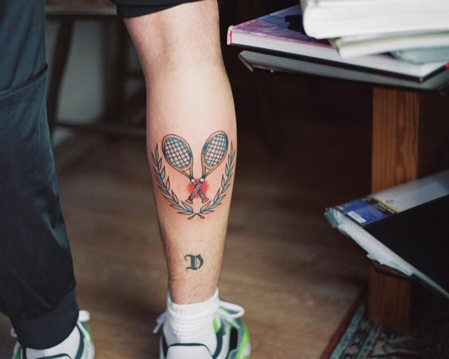 Heartfelt tennis tattoo with rackets and laurels Tattoo Design