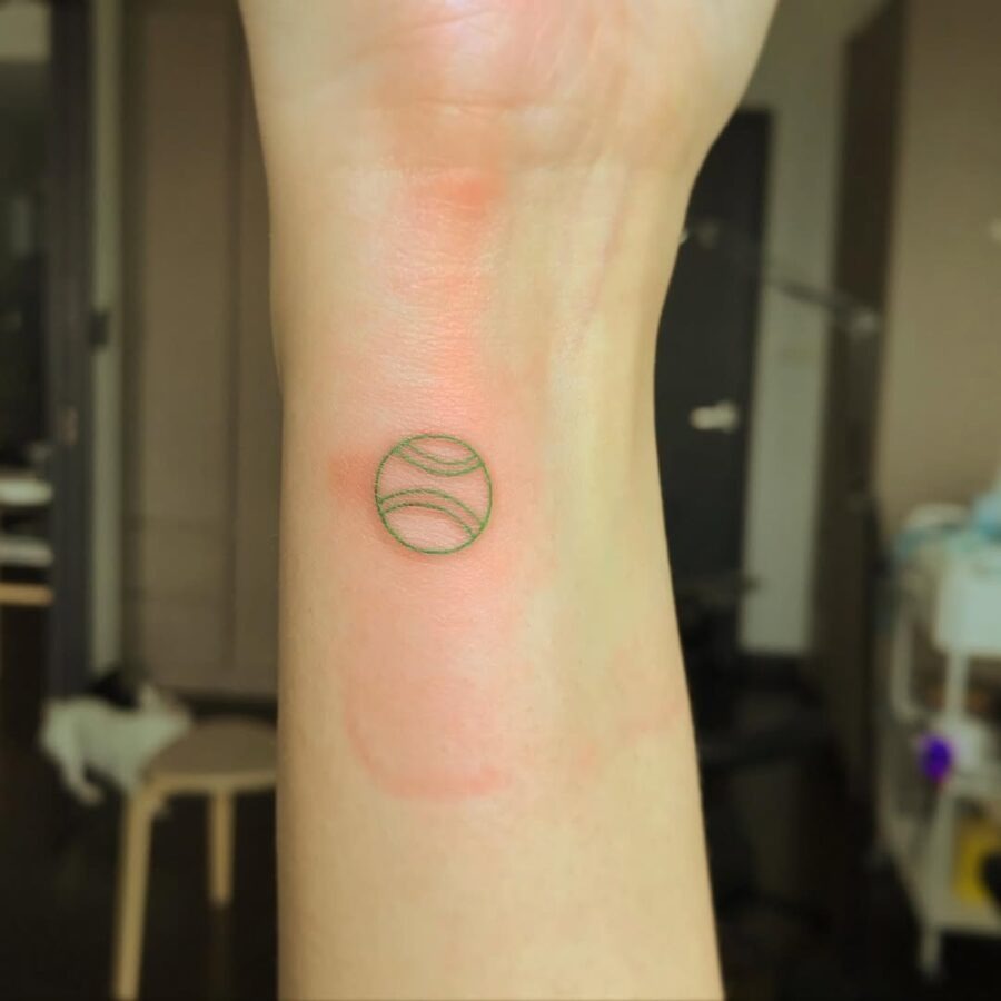 Minimalist Tennis Ball Tattoo on Wrist Tattoo Design