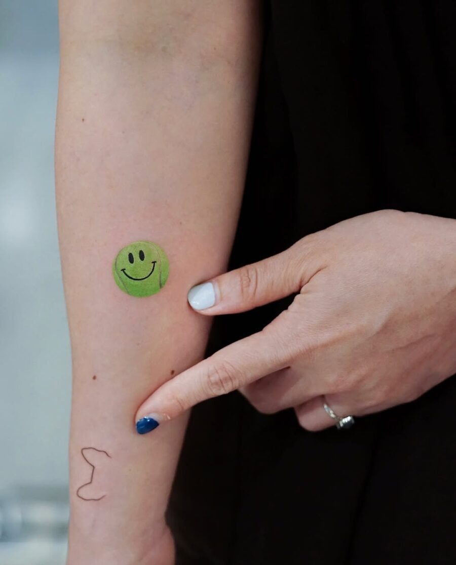 Playful smiley face tennis tattoo design Tattoo Design