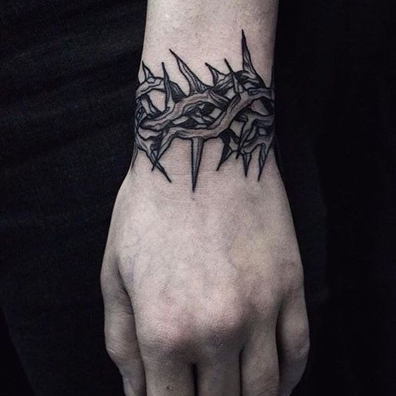 Compact Wrist Thorn Bracelet With Modern Gothic Style, a tattoo design rendered in minimalist fine-line.