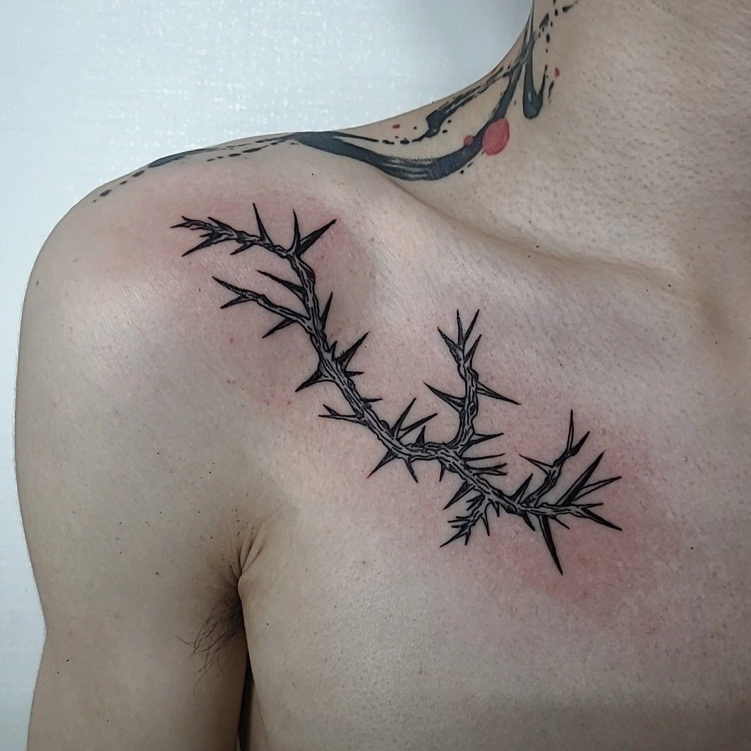Curved Chest Thorn Branch With Elegant Edge, a tattoo design rendered in clean detailed linework for the shoulder.