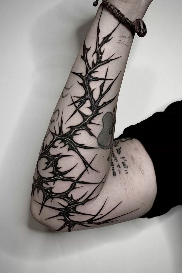 Dense Black Thorn Branch for a Bold Forearm Statement, a tattoo design rendered in blackwork.