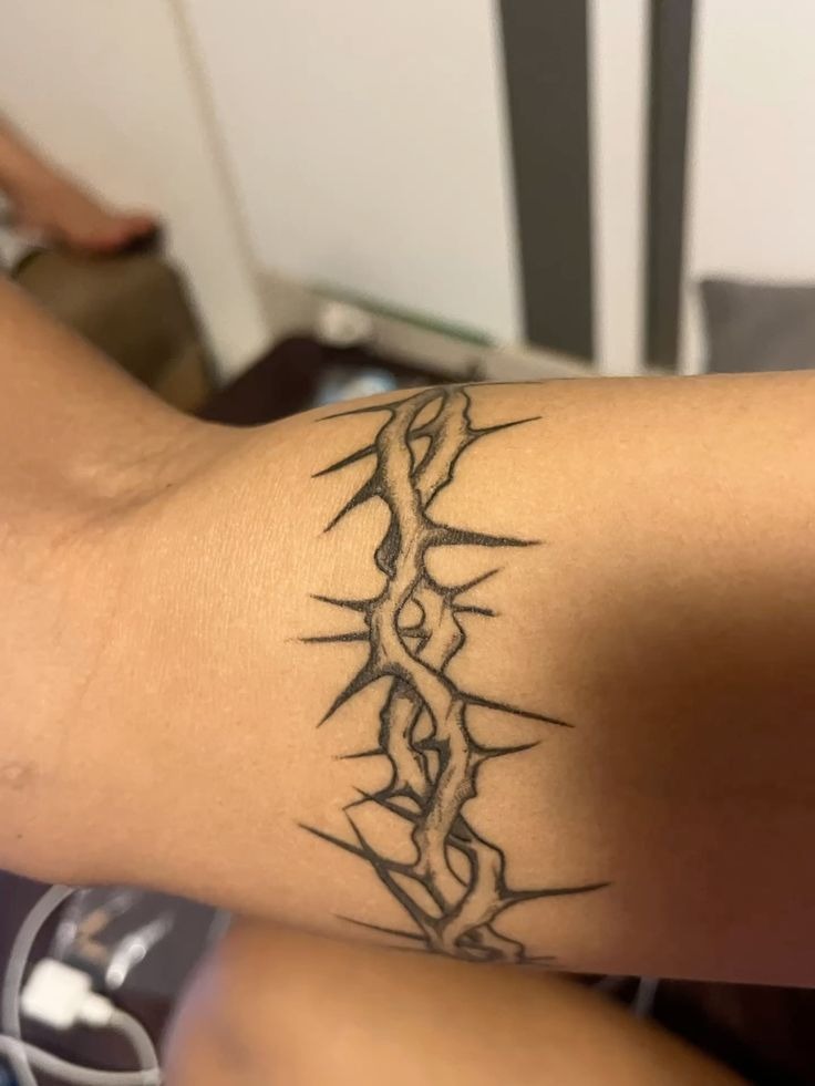 Minimal Thorn Band for a Clean, Quiet Statement, a tattoo design rendered in clean detailed linework.