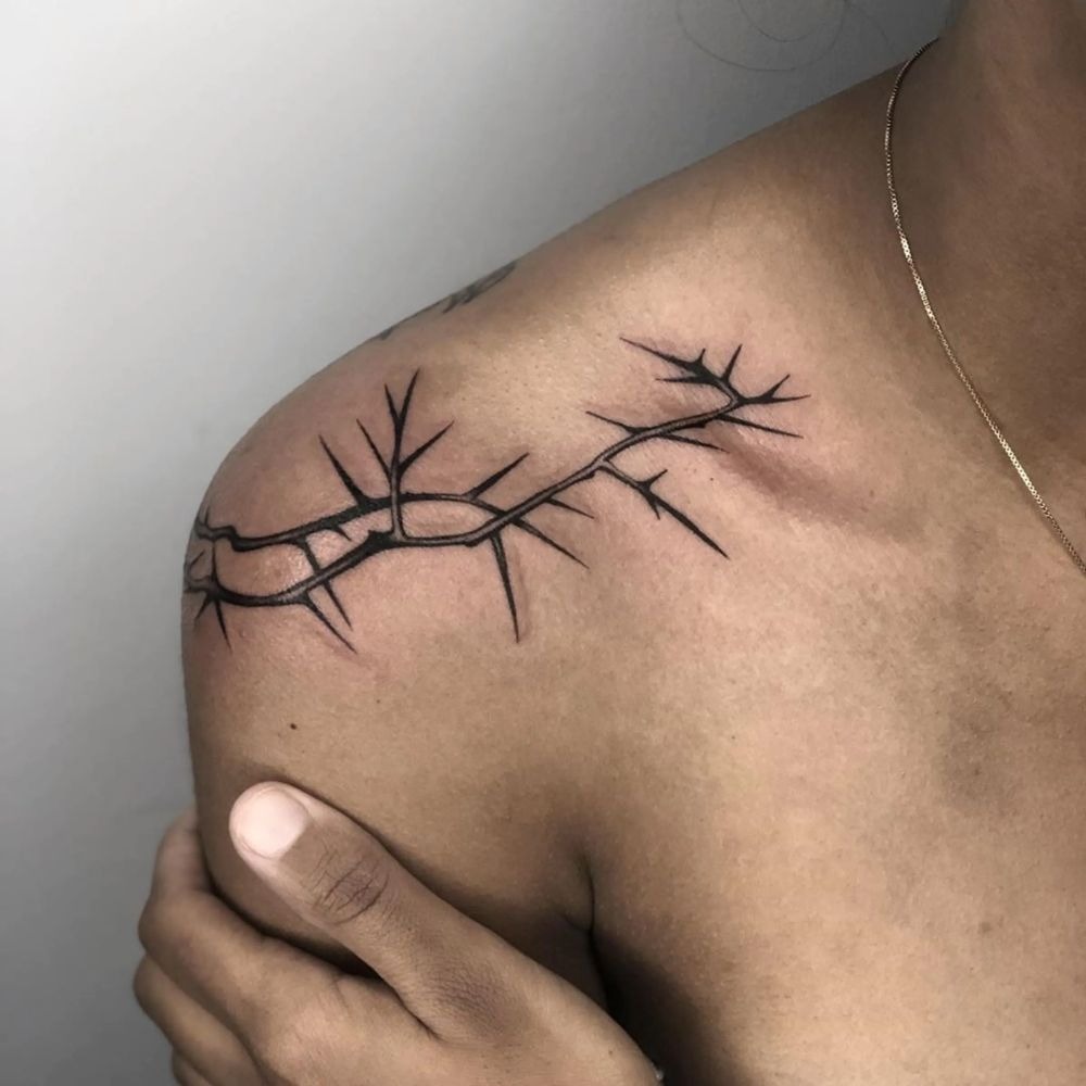 Simple Shoulder Thorn Line With Clean, Modern Appeal, a tattoo design rendered in minimalist fine-line.