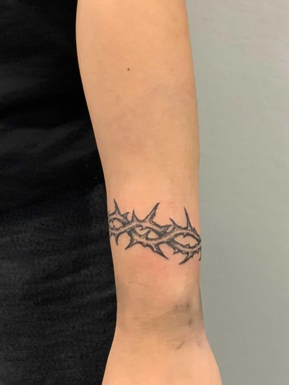 Slim Thorn Wrist Band for an Easy Everyday Look, a tattoo design rendered in clean detailed linework.