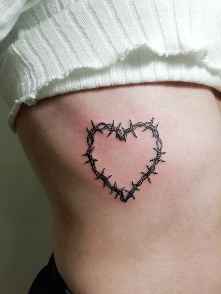 Thorn Heart Tattoo That Feels Sweet, Sharp, and Slightly Dangerous, a tattoo design rendered in clean detailed linework for the arm.