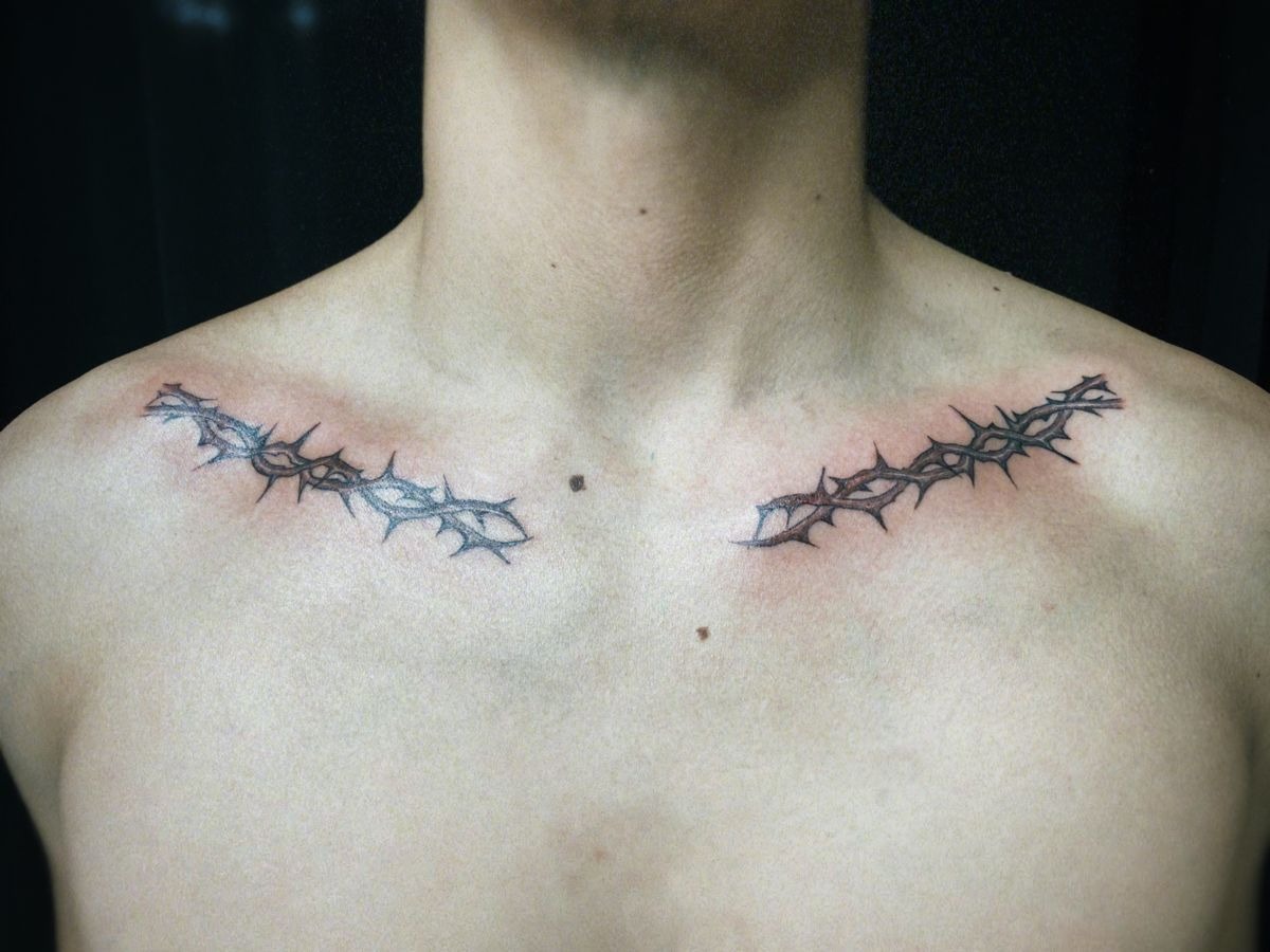 Twin Collarbone Thorn Branches for a Striking Symmetrical Look, a tattoo design rendered in delicate fine-line for the chest.