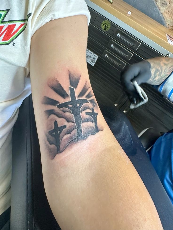 Dramatic Three-Cross Forearm Tattoo With Rays Tattoo Design