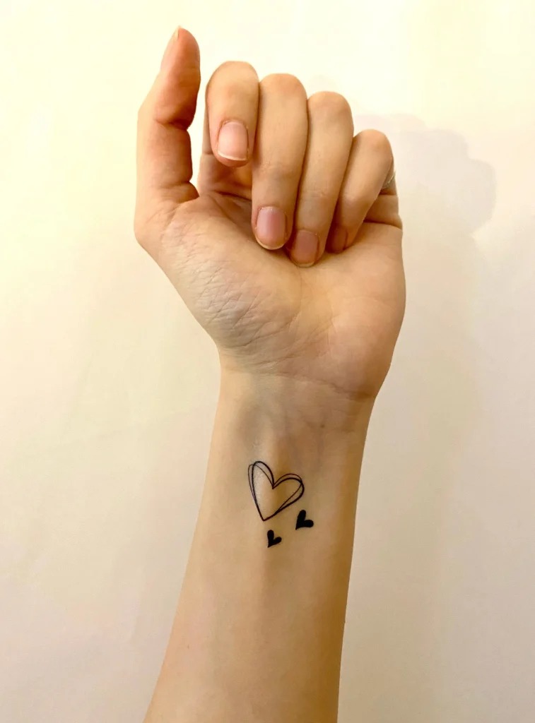 Minimalist Wrist Three Hearts Tattoo with a Modern Twist Tattoo Design