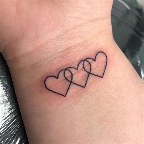 Overlapping Hearts Tattoo on the Wrist Tattoo Design