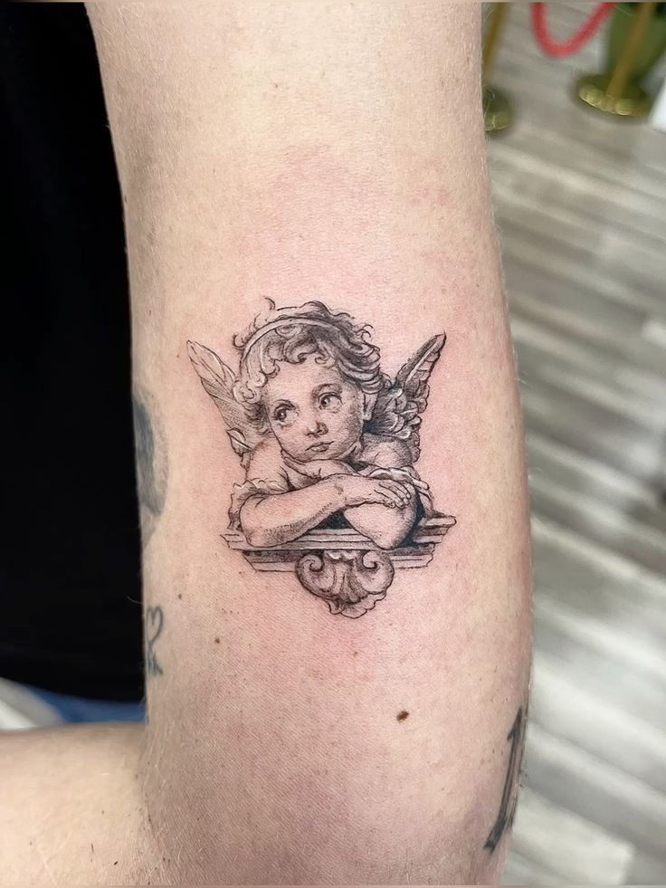 Dainty Cherub Bust on a Ledge Tattoo Design