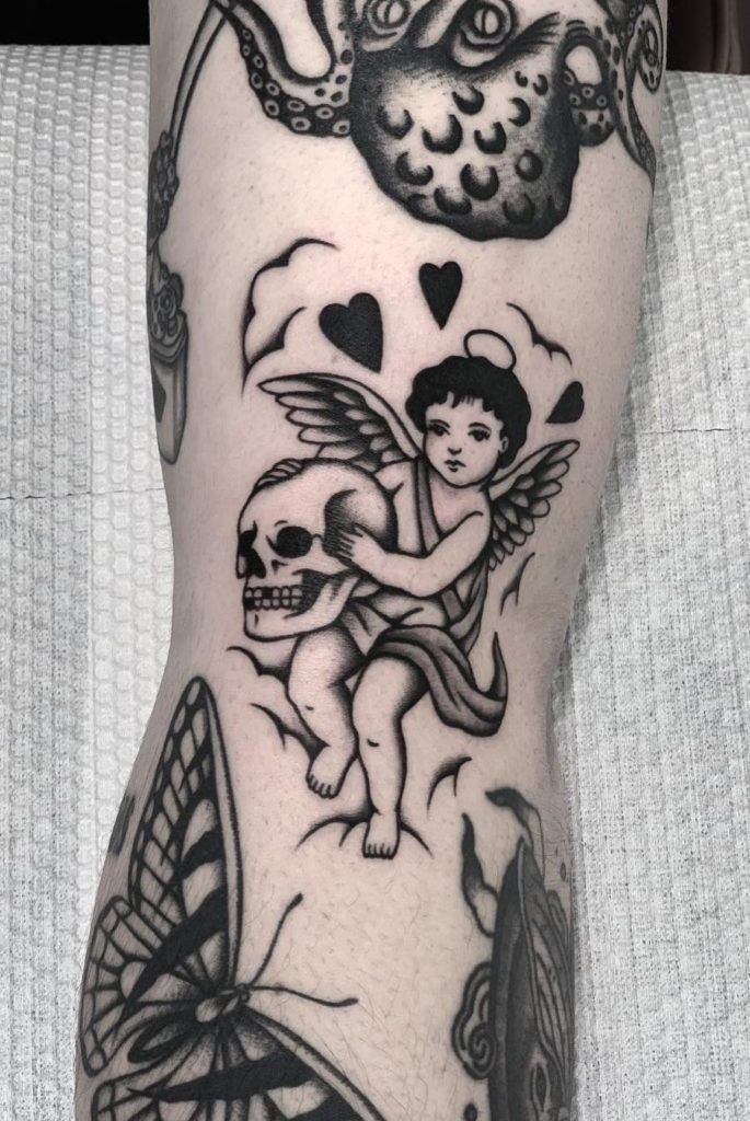 Playful Cherub with Flowers Tattoo Design