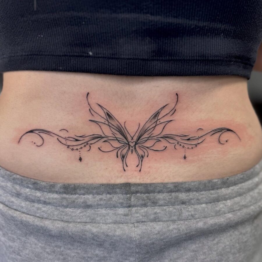 Elegant butterfly tattoo with decorative swirls Tattoo Design