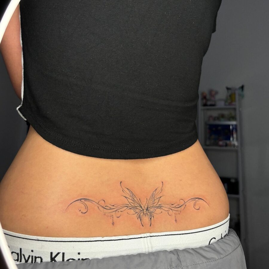 Elegant butterfly tramp stamp tattoo design showcased. Tattoo Design