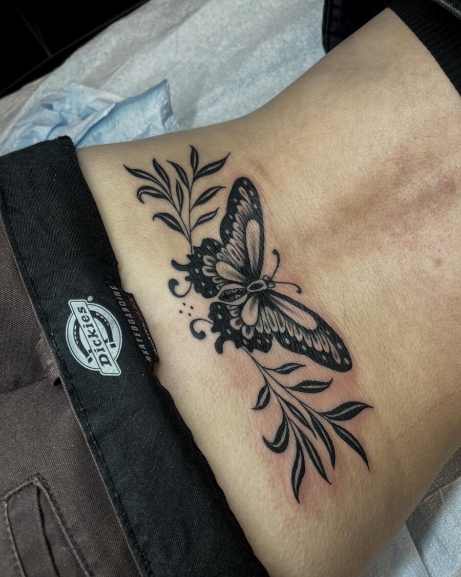 Elegant butterfly tramp stamp with floral accents Tattoo Design