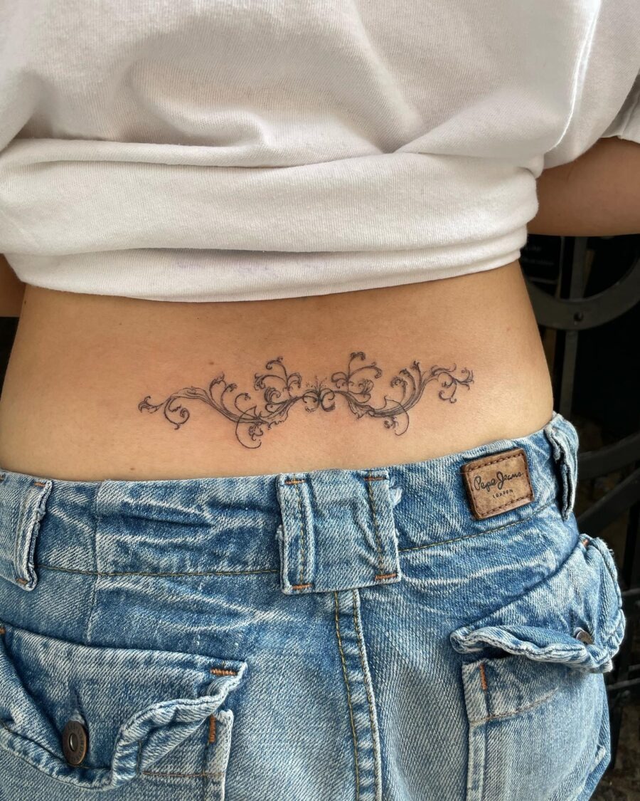 Elegant floral vine design on lower back Tattoo Design