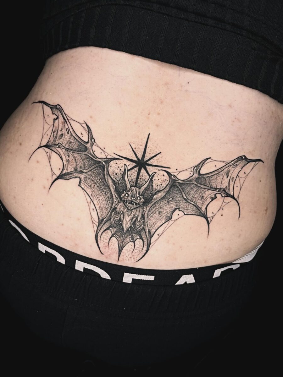 Intricate bat tattoo design on lower back Tattoo Design