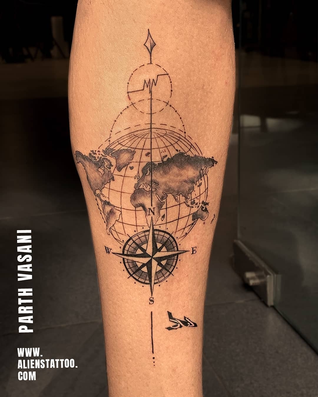 Adventure-inspired compass and world map tattoo Tattoo Design