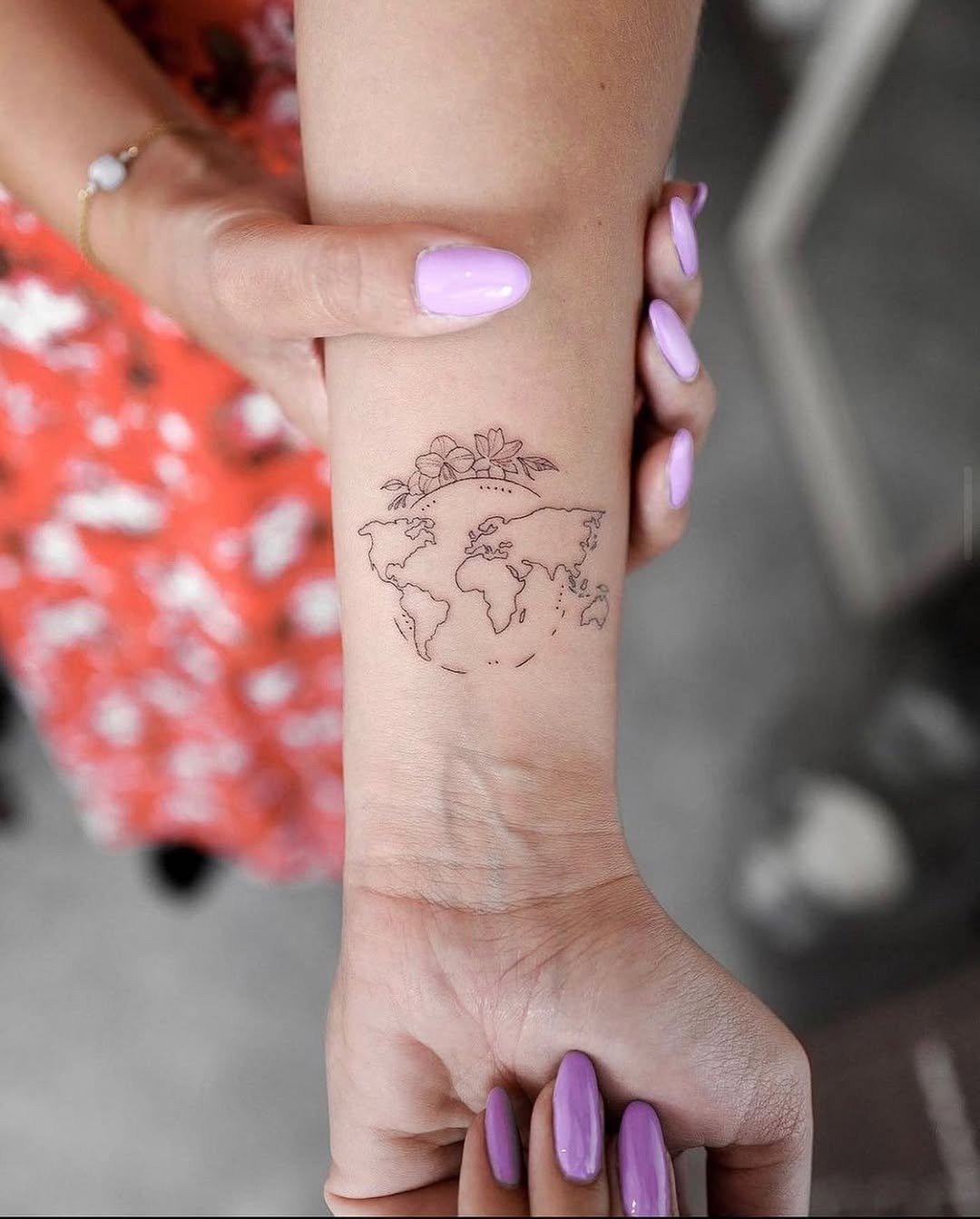 Delicate world map tattoo with floral details Tattoo Design