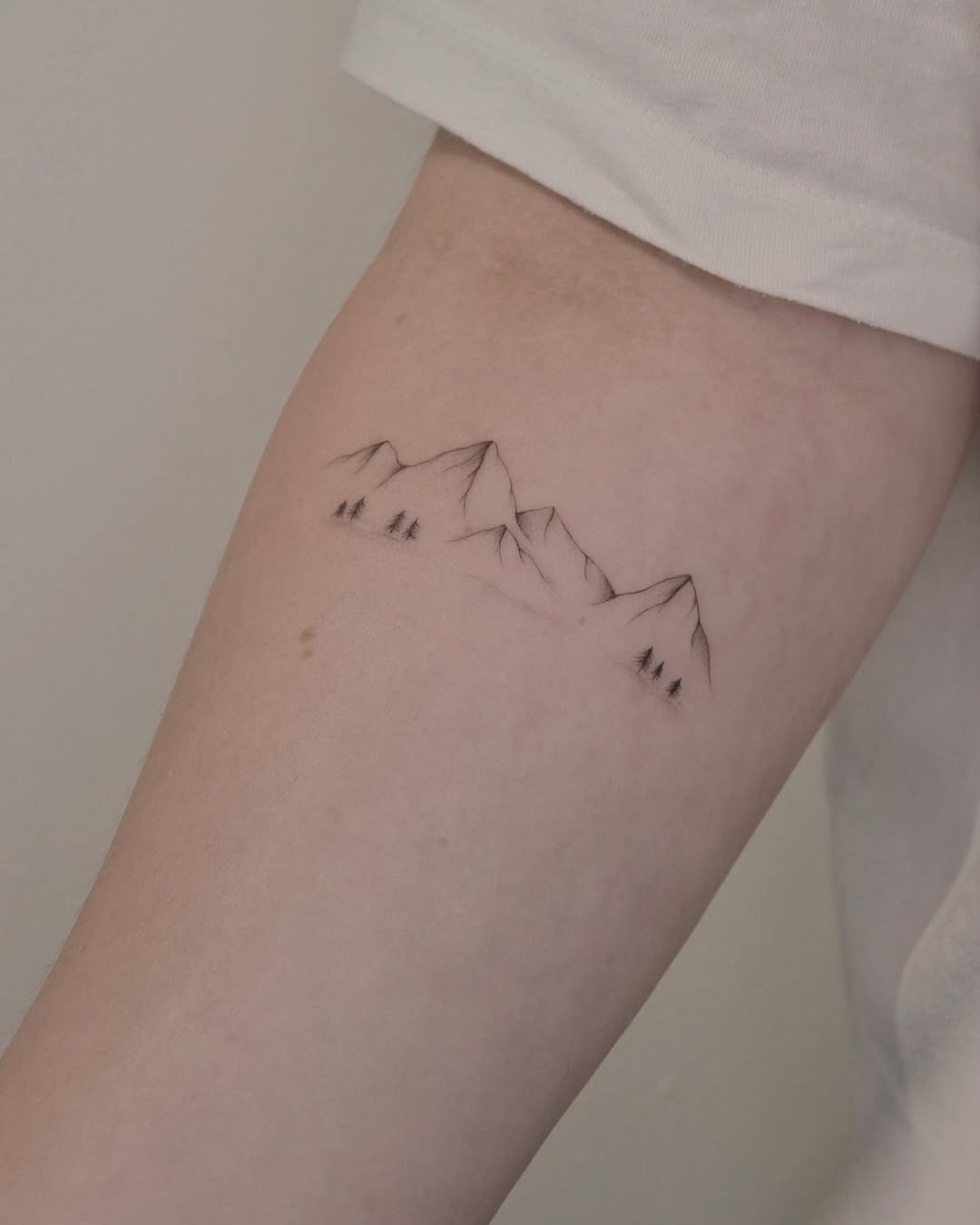 Minimalist mountain tattoo with a natural vibe Tattoo Design