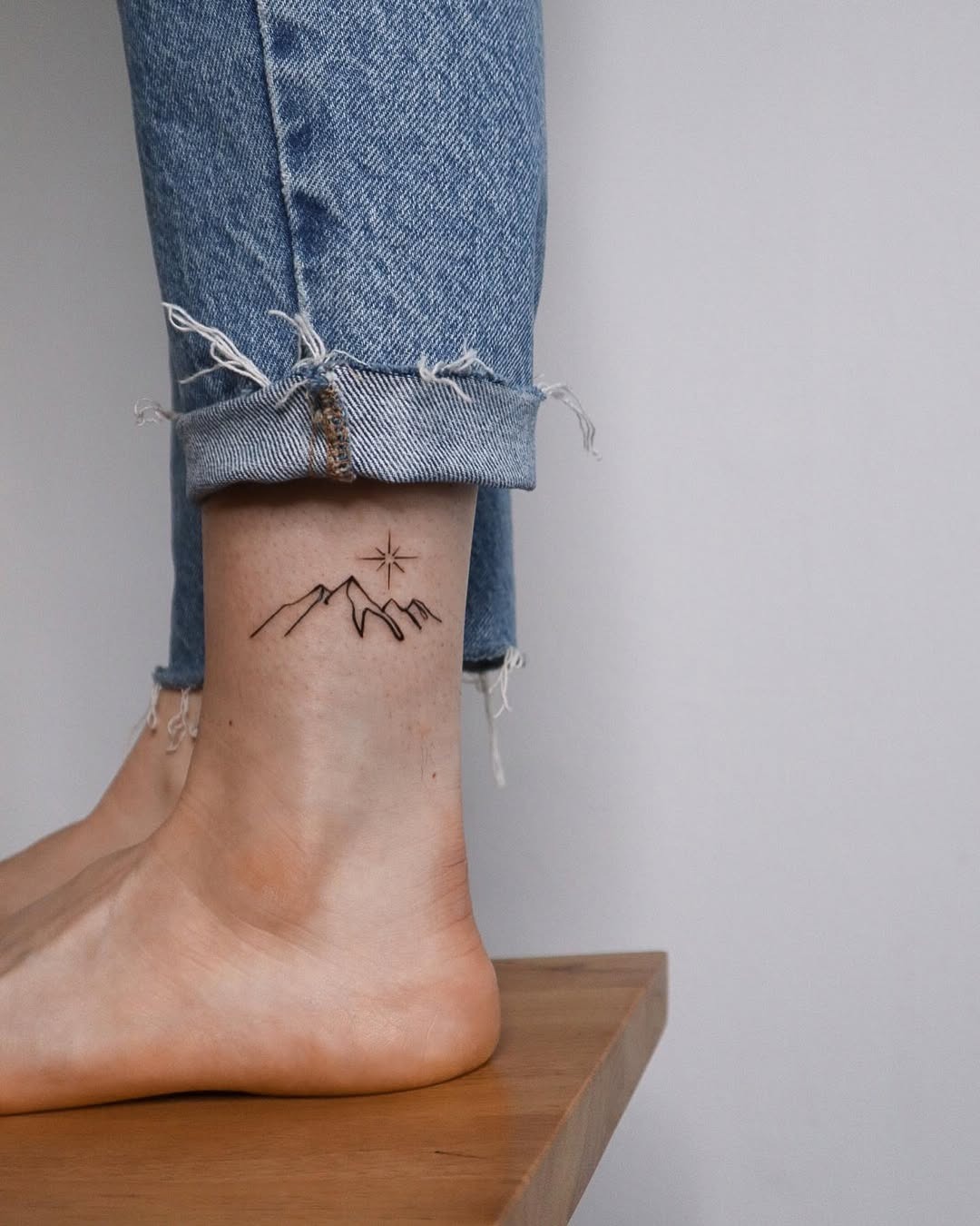 Stylish ankle tattoo with mountain sunset design Tattoo Design