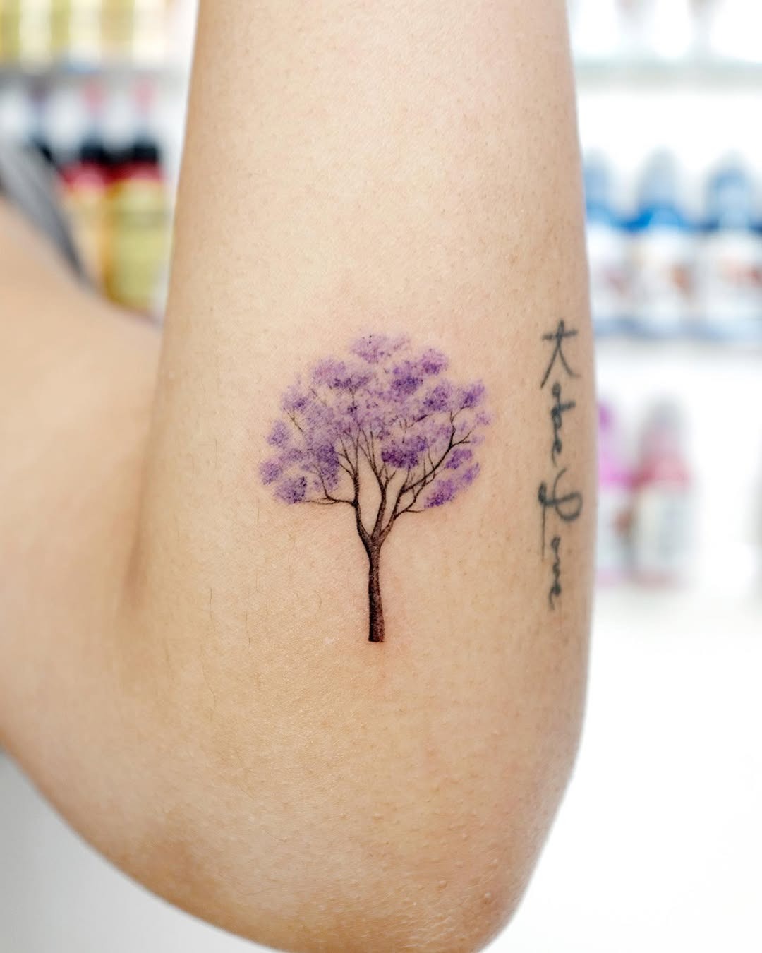 Delicate purple tree tattoo on forearm Tattoo Design