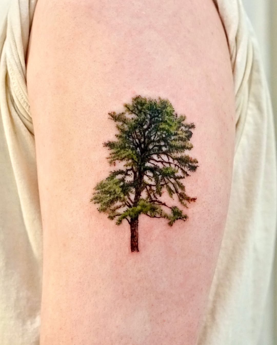 Elegant tree tattoo with vibrant green hues Tattoo Design