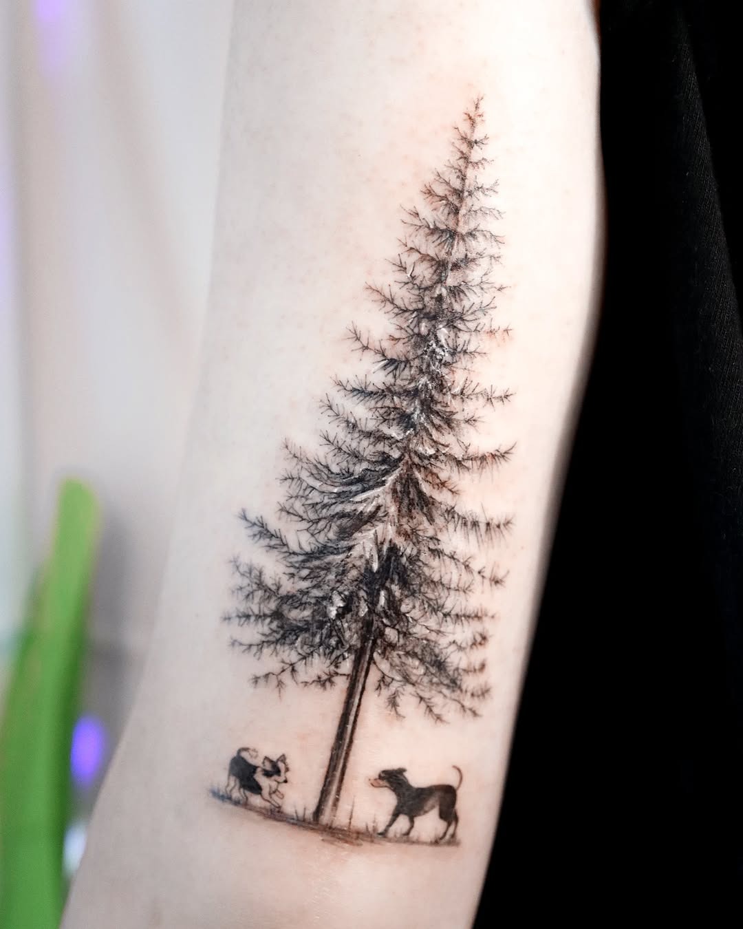 Nature-inspired tree tattoo with playful dogs Tattoo Design
