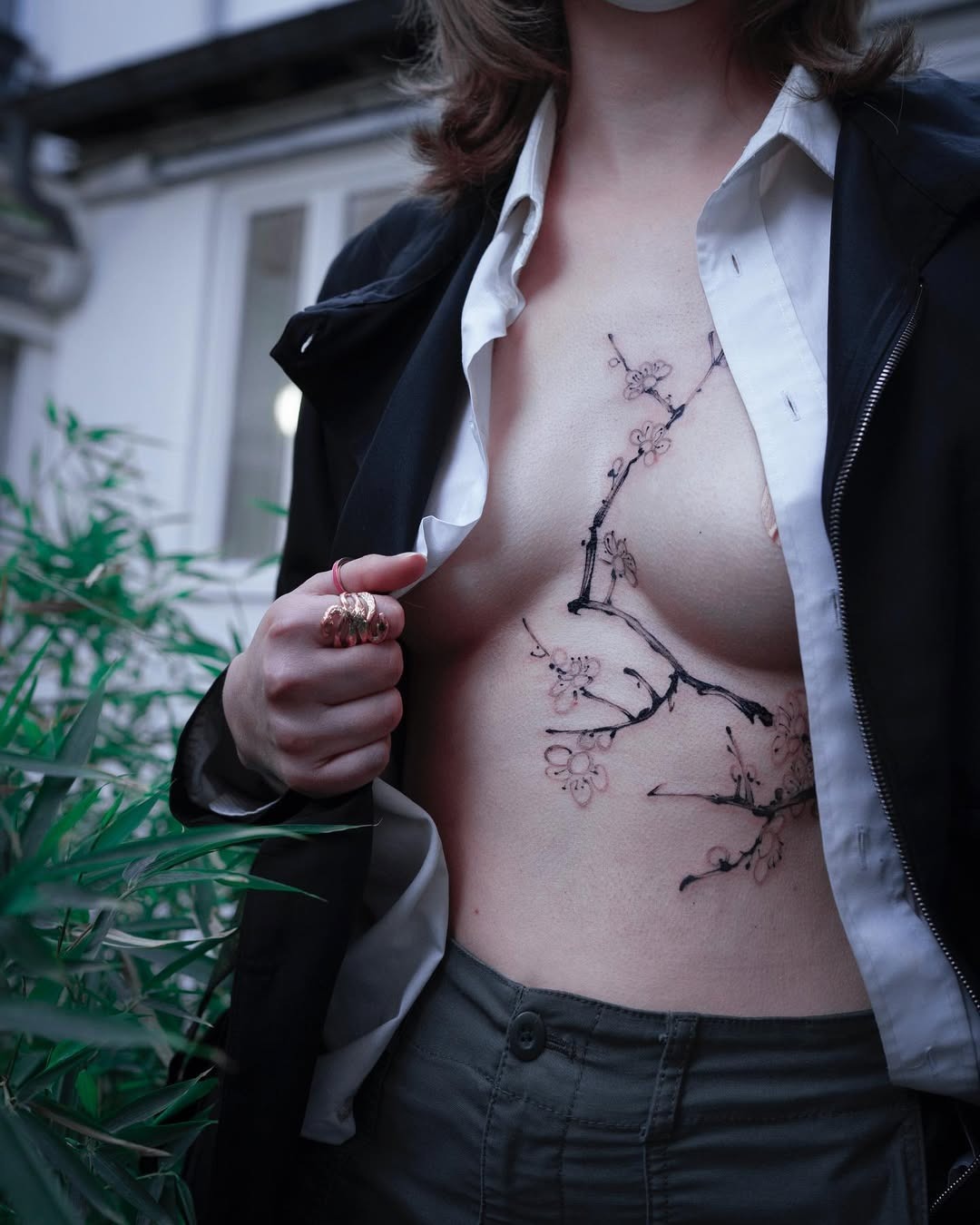 Silhouette resting under a detailed tree tattoo Tattoo Design