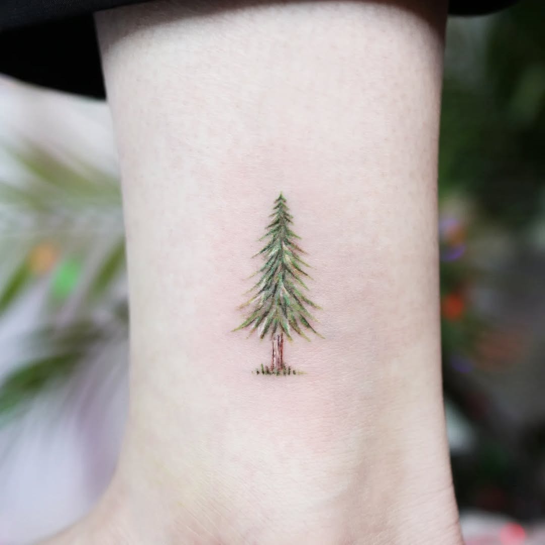 Whimsical orange tree tattoo on the arm Tattoo Design