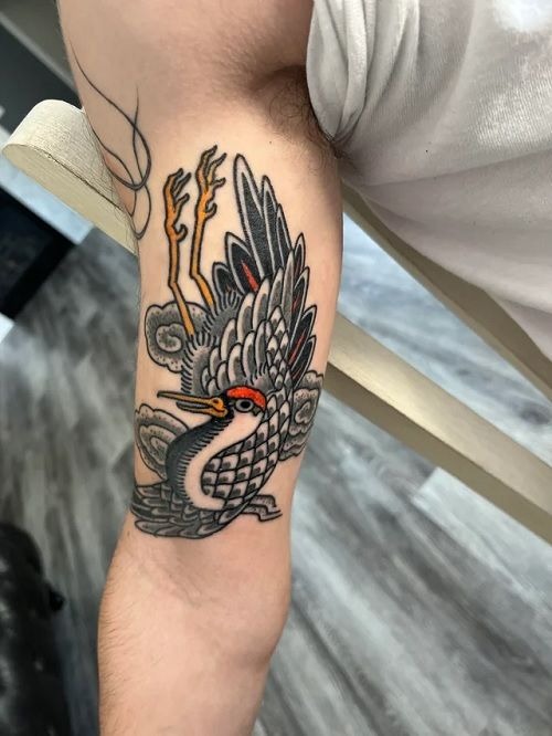 American Traditional Bird Tricep Tattoo, a tattoo design rendered in bold traditional for the back.