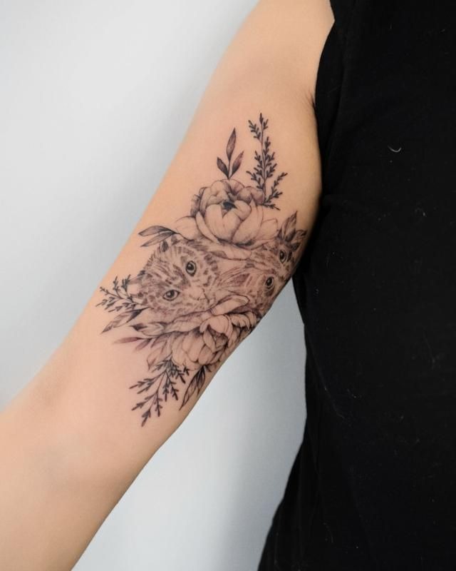 Fine Line Cat + Floral Tricep Tattoo, a tattoo design rendered in clean detailed linework for the arm.