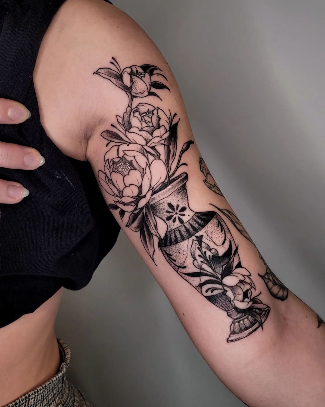 Floral Vase Tricep Tattoo With Dotwork, a tattoo design rendered in dotwork for the arm.