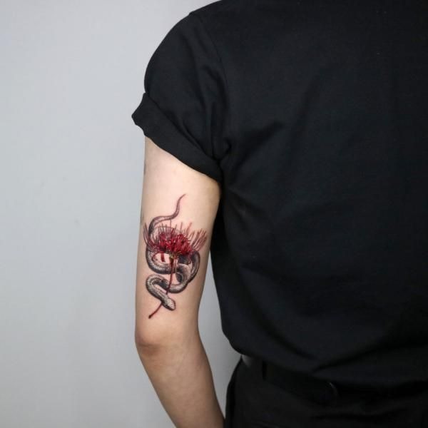 Japanese-Inspired Snake and Flower Tricep Tattoo, a tattoo design rendered in clean detailed linework for the arm.