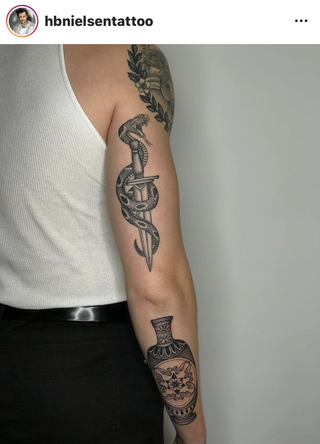 Snake and Dagger Men’s Aesthetic Tricep Tattoo, a tattoo design rendered in bold.