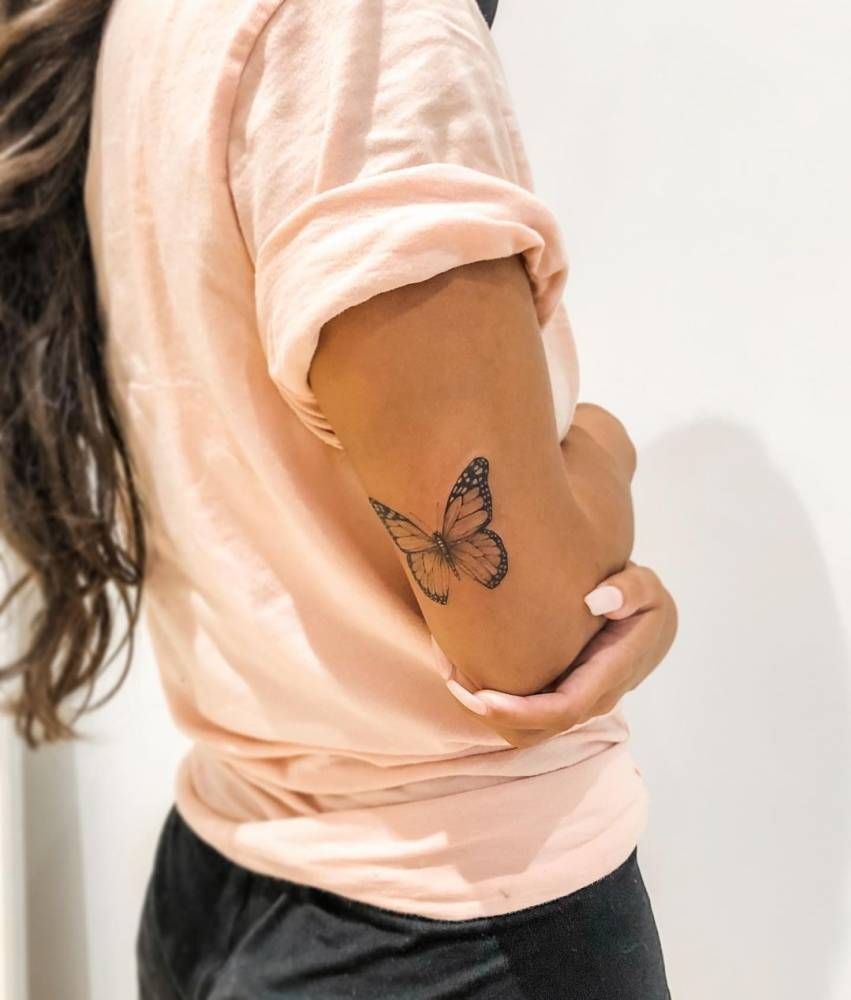 Tiny Butterfly Tricep Tattoo, a tattoo design rendered in clean detailed linework.