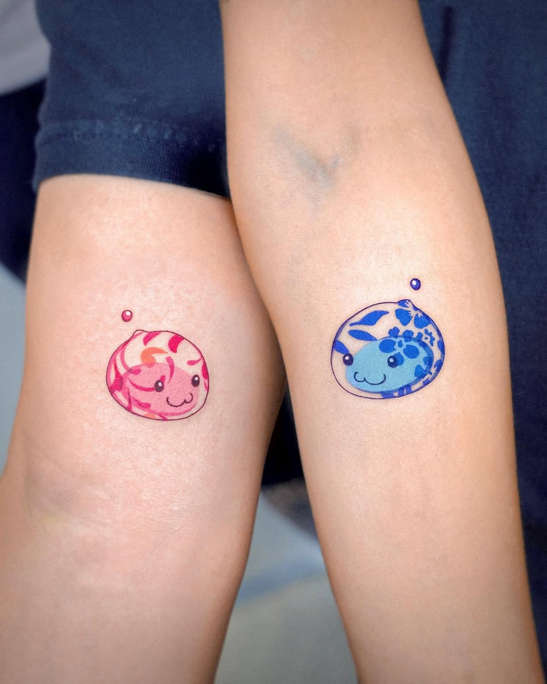 Adorable twin tattoos of playful aquatic creatures Tattoo Design