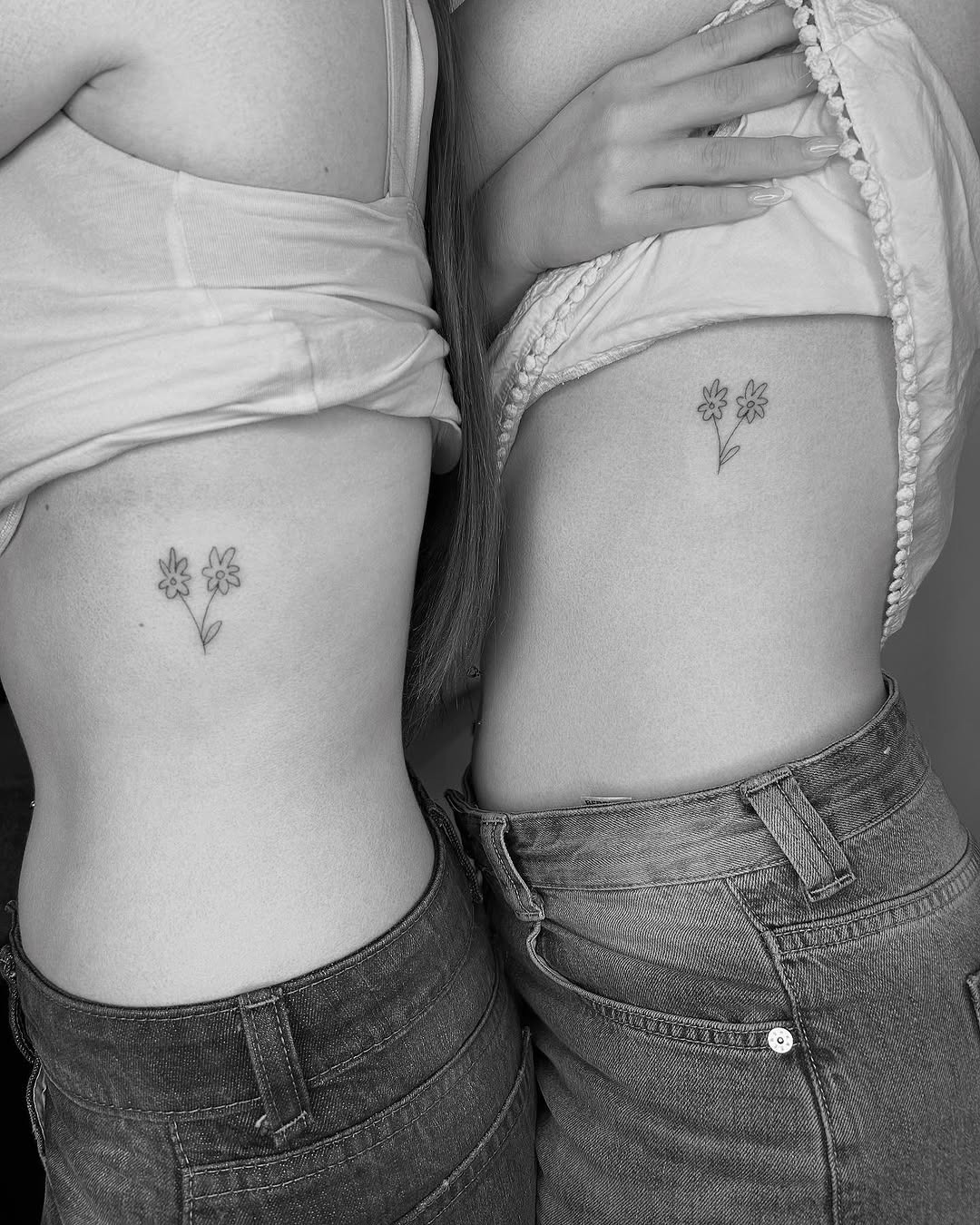 Delicate floral twin tattoos on skin Tattoo Design